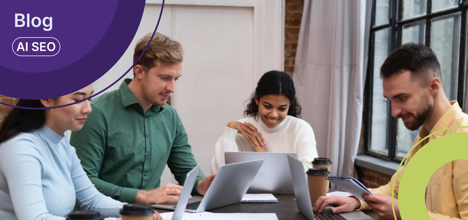 Four teammates working on laptops around a table, smiling as one checks his phone, representing digital marketing for small businesses collaboration.