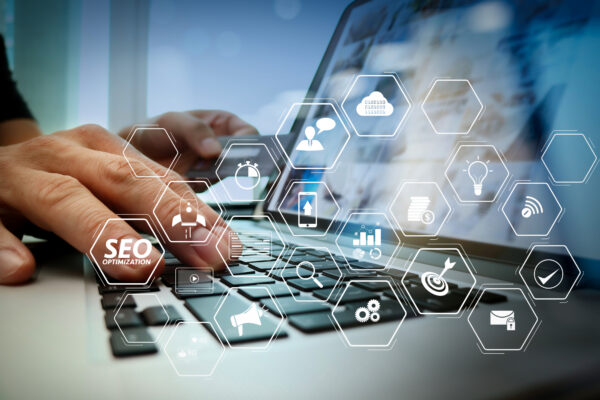 Digital marketer organizing SEO topic clusters and interconnected content strategy on a laptop to prevent common SEO mistakes and build topical authority.
